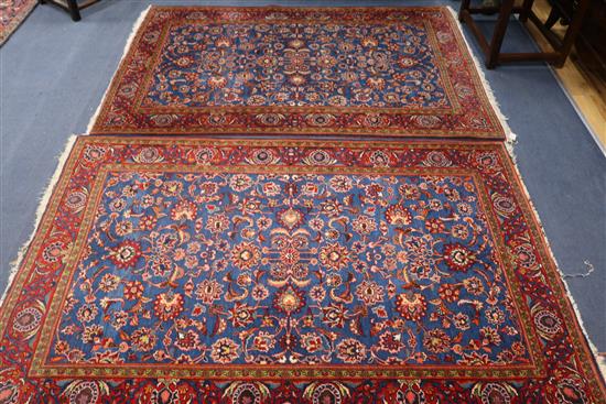 A pair of Persian red and blue ground rugs, 6ft 10in by 4ft 6in.